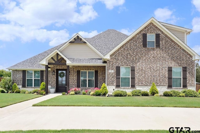 109 Nathan, Chandler, TX 75758 - view of front of property with brick siding, a front lawn, and a shingled roof