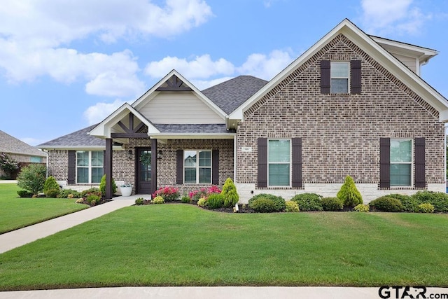 109 Nathan, Chandler, TX 75758 - view of front of property featuring brick siding, a front lawn, and a shingled roof