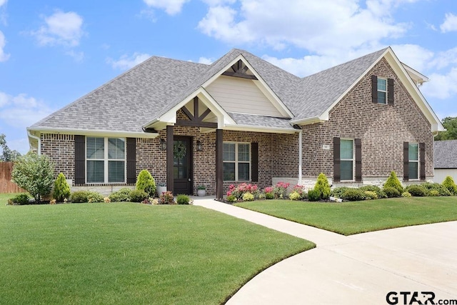 109 Nathan, Chandler, TX 75758 - view of front facade featuring brick siding, roof with shingles, and a front lawn