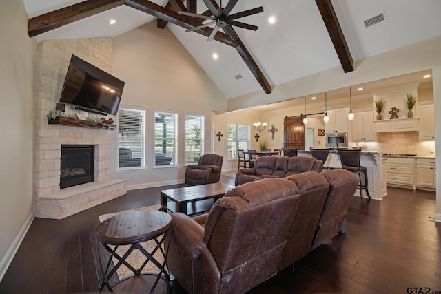 109 Nathan, Chandler, TX 75758 - living area featuring a fireplace, high vaulted ceiling, a chandelier, ceiling fan, and beamed ceiling