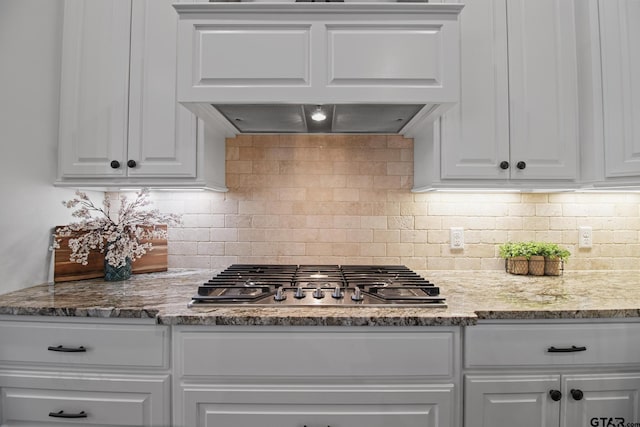 109 Nathan, Chandler, TX 75758 - kitchen with stainless steel gas stovetop, custom range hood, white cabinets, and decorative backsplash