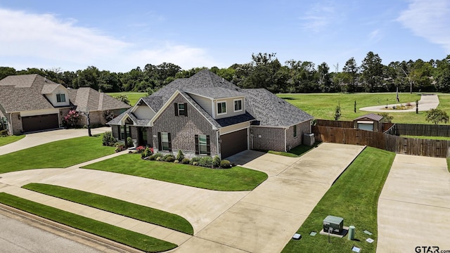 109 Nathan, Chandler, TX 75758 - view of front of property with driveway, brick siding, an attached garage, and view of wooded area