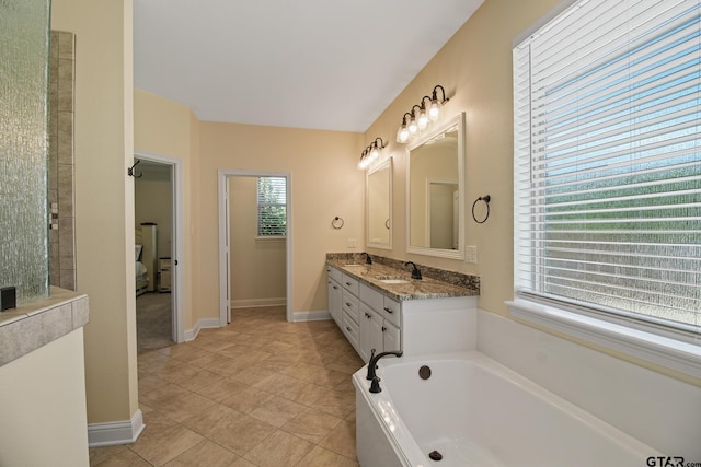 109 Nathan, Chandler, TX 75758 - full bathroom featuring a bath, double vanity, and tile patterned floors