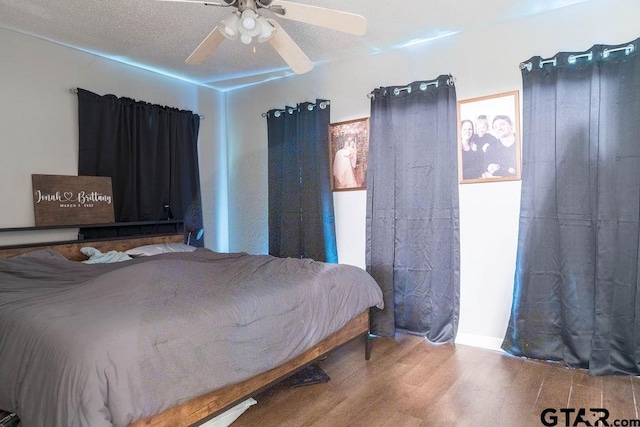 bedroom featuring a ceiling fan and wood finished floors