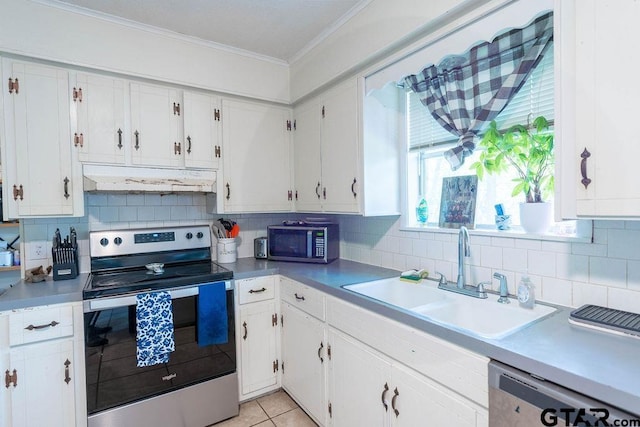 kitchen with crown molding, a sink, under cabinet range hood, stainless steel appliances, and white cabinetry