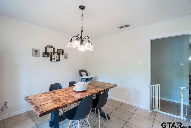 dining space featuring light tile patterned flooring, a notable chandelier, visible vents, and ornamental molding
