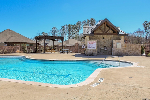 community pool with a patio and fence