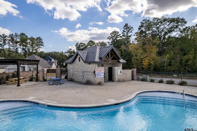 community pool featuring a patio area, fence, and a pergola