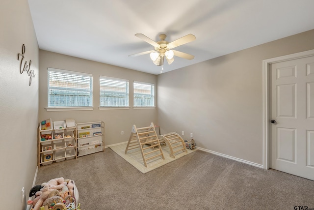 playroom featuring carpet, baseboards, and a ceiling fan