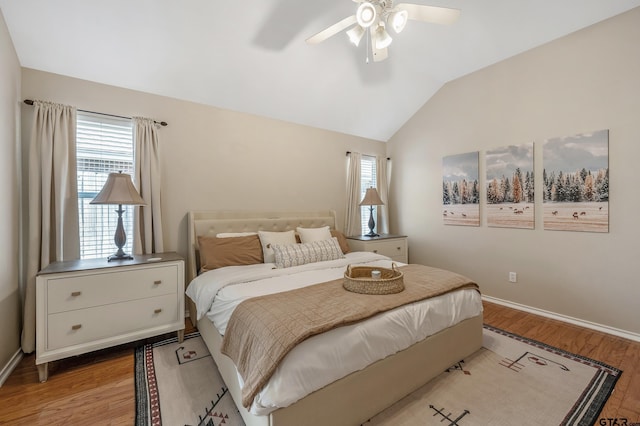 bedroom featuring light wood-style flooring, multiple windows, and vaulted ceiling