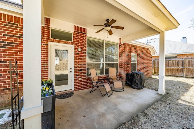 view of patio featuring a ceiling fan, fence, and grilling area