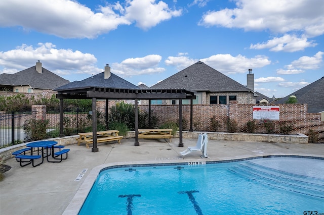 community pool with fence, a pergola, and a patio