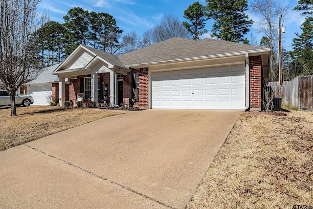 view of front of property with a garage, fence, concrete driveway, and brick siding