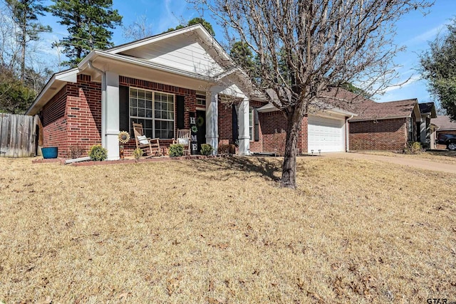 view of front of property featuring brick siding, a porch, an attached garage, a front yard, and fence