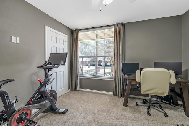 carpeted home office with a ceiling fan and baseboards