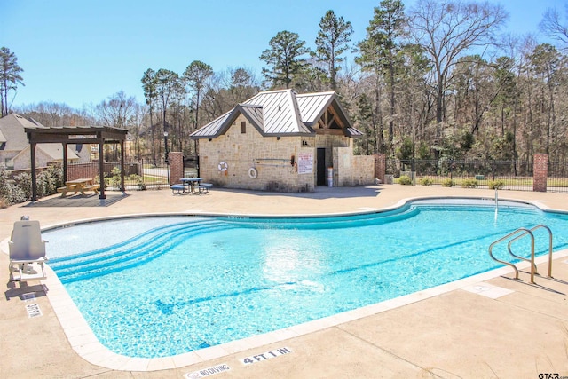 community pool featuring a patio and fence