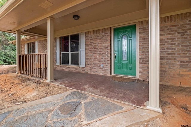 view of exterior entry featuring a porch