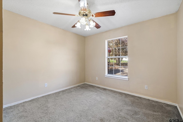 spare room featuring ceiling fan, carpet floors, and a textured ceiling