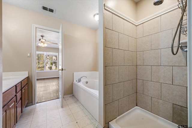 bathroom with vanity, a textured ceiling, ceiling fan, and independent shower and bath