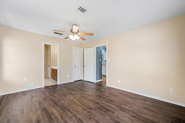 unfurnished bedroom with ensuite bath, ceiling fan, dark hardwood / wood-style flooring, and a textured ceiling