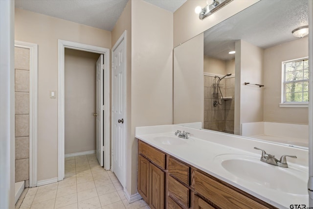 bathroom featuring tile patterned flooring, vanity, separate shower and tub, and a textured ceiling