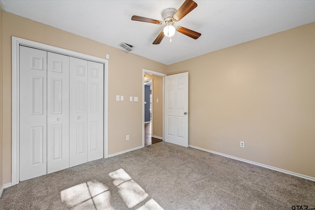 unfurnished bedroom featuring carpet flooring, a closet, and ceiling fan