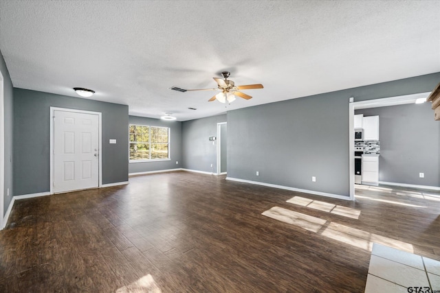 unfurnished living room with a textured ceiling, dark hardwood / wood-style flooring, and ceiling fan