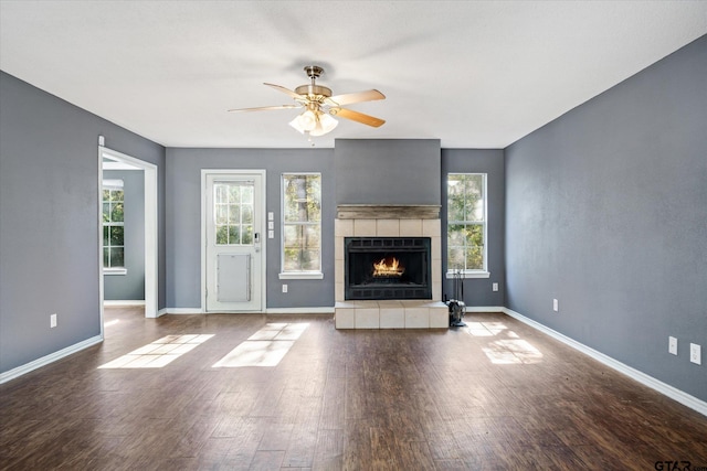 unfurnished living room featuring ceiling fan, a fireplace, and wood-type flooring