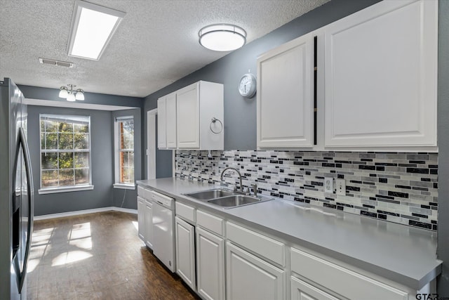 kitchen with stainless steel refrigerator with ice dispenser, white dishwasher, dark wood-type flooring, sink, and white cabinetry