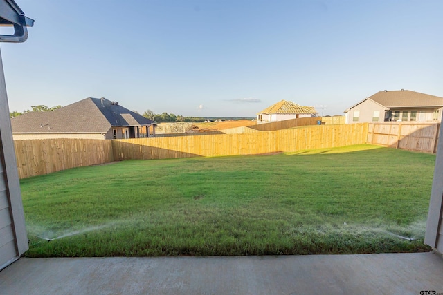 view of yard with a fenced backyard