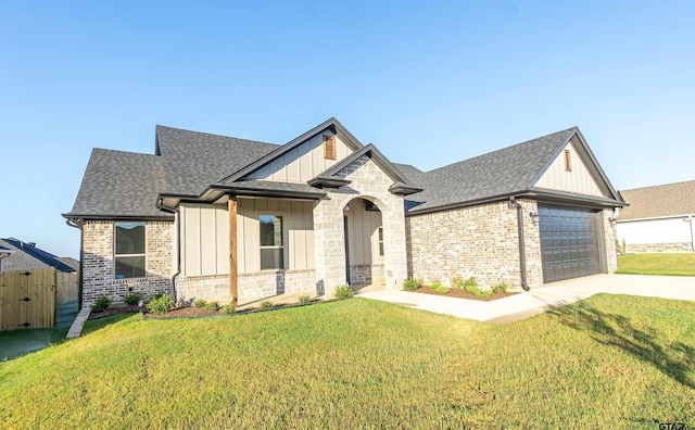 view of front of property featuring a front lawn, board and batten siding, roof with shingles, and concrete driveway
