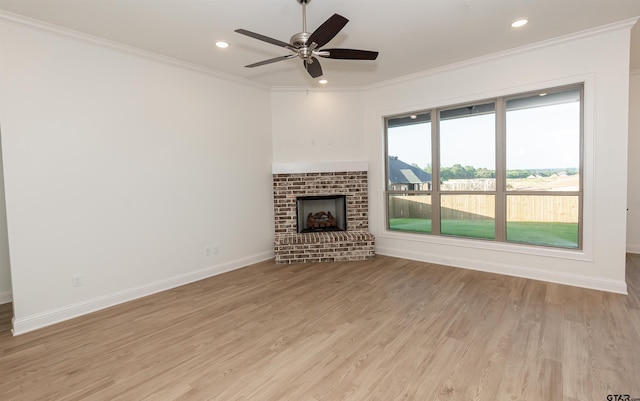 unfurnished living room featuring ornamental molding, a fireplace, light wood-style floors, recessed lighting, and a ceiling fan