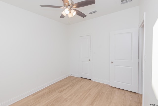 unfurnished bedroom with a ceiling fan, baseboards, visible vents, and light wood-style flooring