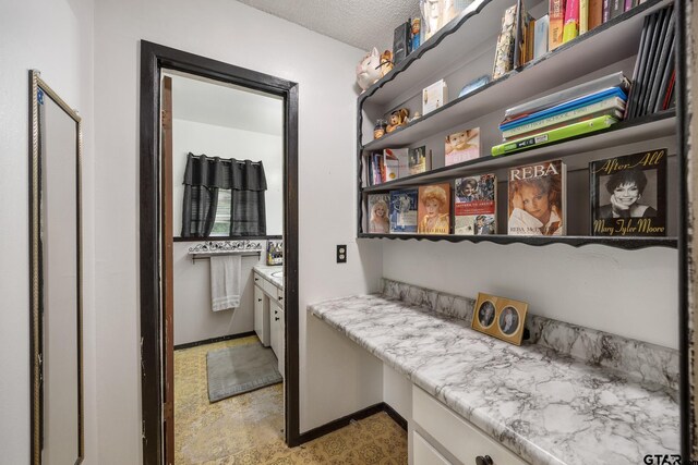 9961 Creek Bend Dr, Tyler, TX 75707 - hallway featuring baseboards and a textured ceiling