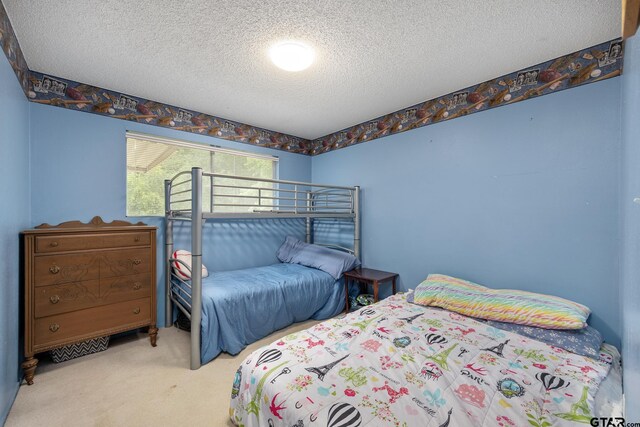 9961 Creek Bend Dr, Tyler, TX 75707 - carpeted bedroom featuring a textured ceiling