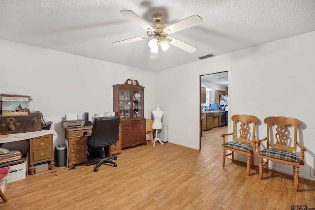 9961 Creek Bend Dr, Tyler, TX 75707 - office space with light wood-type flooring, a ceiling fan, and a textured ceiling