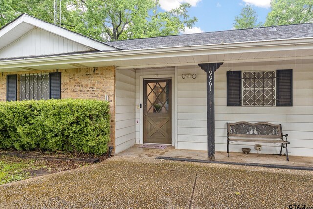 9961 Creek Bend Dr, Tyler, TX 75707 - entrance to property with a shingled roof and brick siding