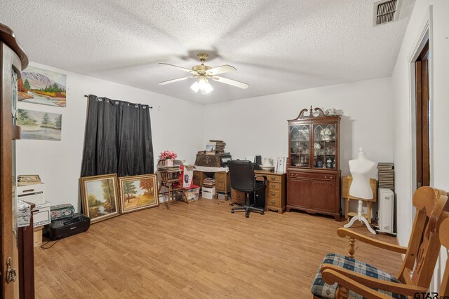 9961 Creek Bend Dr, Tyler, TX 75707 - office space featuring a ceiling fan, light wood finished floors, and a textured ceiling