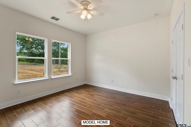 unfurnished room with ceiling fan and dark hardwood / wood-style floors