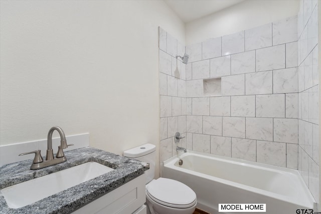 full bathroom with vanity, toilet, and tiled shower / bath