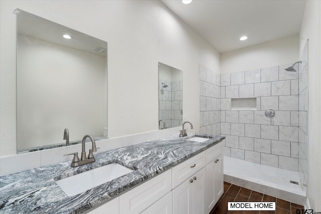 bathroom with vanity, hardwood / wood-style floors, and a tile shower