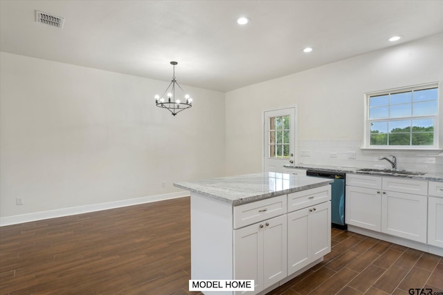 kitchen featuring dark wood-type flooring, white cabinetry, pendant lighting, and sink