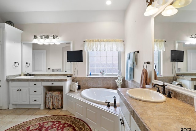 bathroom with vanity, a tub, and tile patterned floors