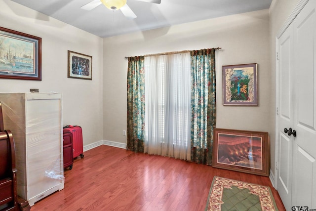 living area featuring hardwood / wood-style flooring, a wealth of natural light, and ceiling fan