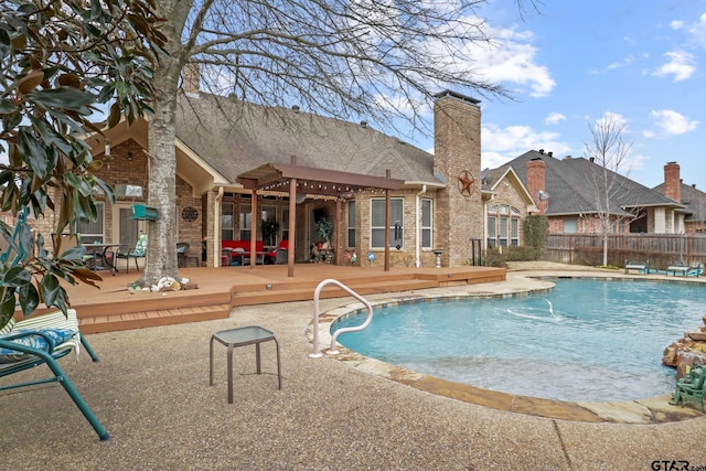 view of swimming pool with a deck, a patio, and a diving board