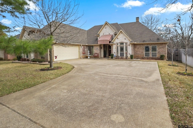 view of front of house with a garage and a front yard