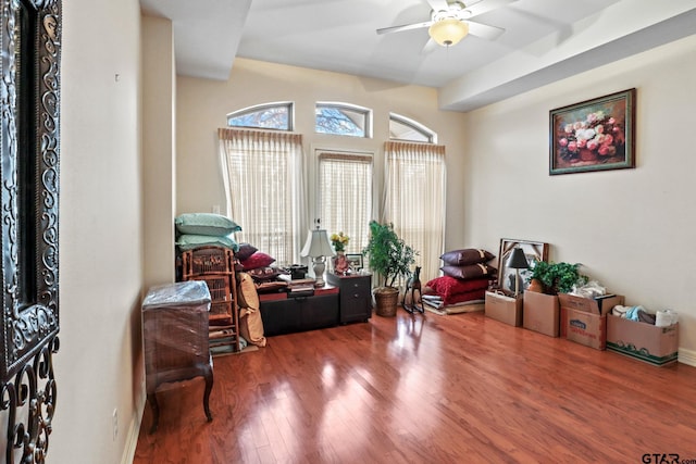 living area with ceiling fan and wood-type flooring