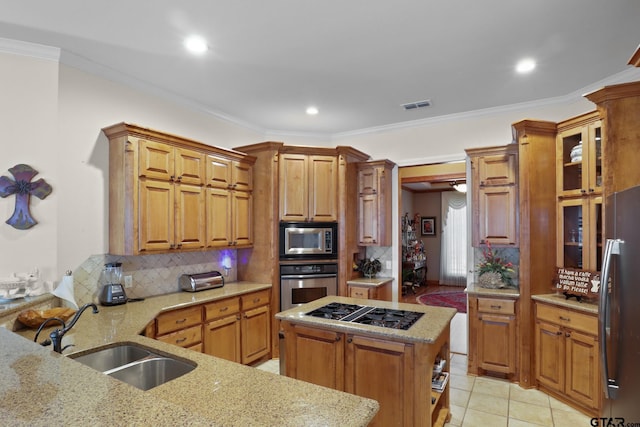 kitchen featuring a center island, appliances with stainless steel finishes, sink, and light stone counters