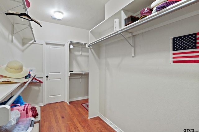 walk in closet featuring hardwood / wood-style floors