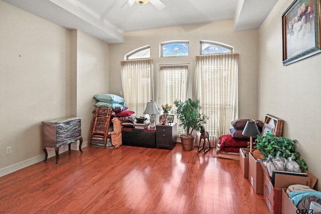 living area with hardwood / wood-style flooring and ceiling fan